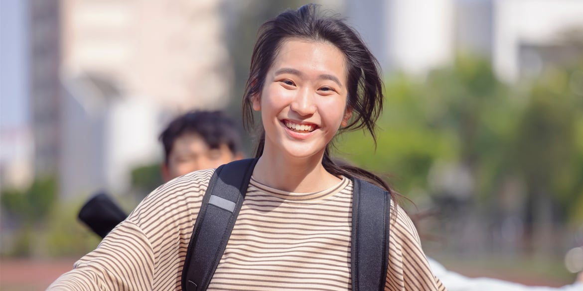 A young female teenager smiling at the camera