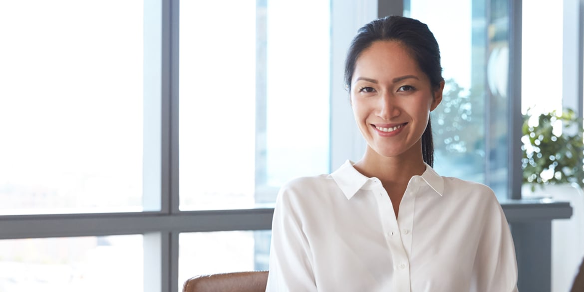 A professional-looking woman in her 30's looking at the camera