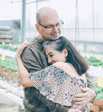 Hleahty middle-aged couple embracing each other